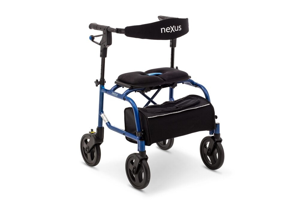 Blue NeXus Mobility Walker standing folded with storage bag attached