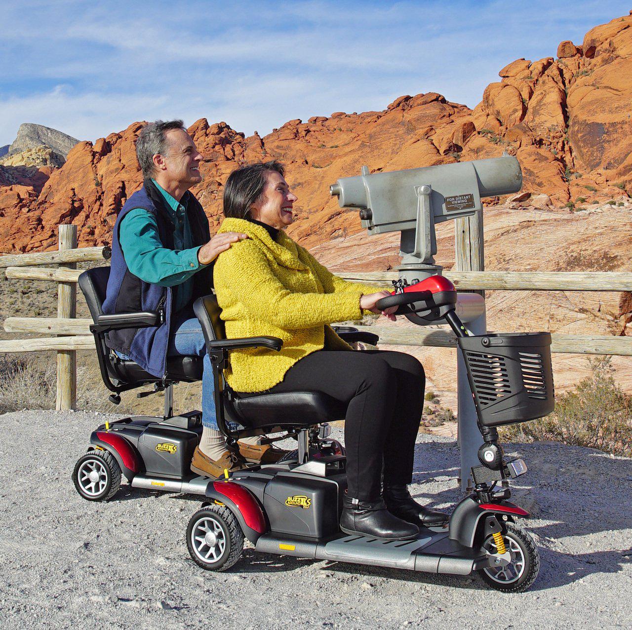A couple driving Golden Buzzaround Extreme 3-Wheel Mobility Scooter
